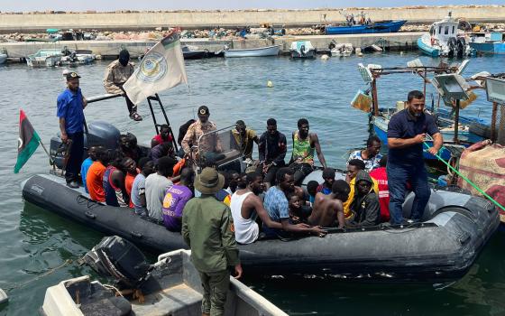 Migrants, whose boats sank in the sea and who were rescued by the Libyan Coast Guards at the Mediterranean Sea, arrive on a boat at the port in Garaboli, Libya, June 8. (OSV News/Reuters/Ayman al-Sahili)