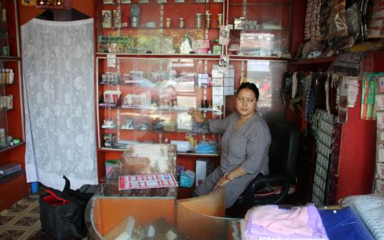 Woman stands in a shop.