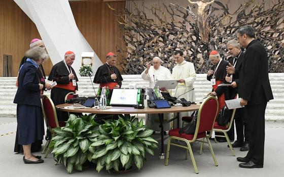 Pope Francis gives his blessing at the conclusion of the assembly of the Synod of Bishops' last working session Oct. 28 in the Paul VI Hall at the Vatican. (CNS/Vatican Media)