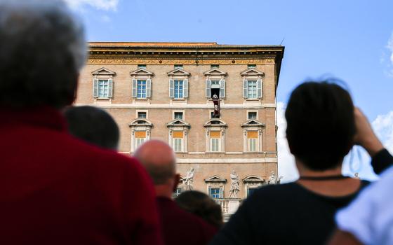 Pope Francis speaks to visitors gathered to pray the Angelus in St. Peter's Square at the Vatican Oct. 29. (CNS/Lola Gomez)