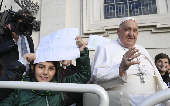 Children ride with Pope Francis in the popemobile during the pope's general audience in St. Peter's Square at the Vatican Nov. 22. (CNS/Vatican Media)