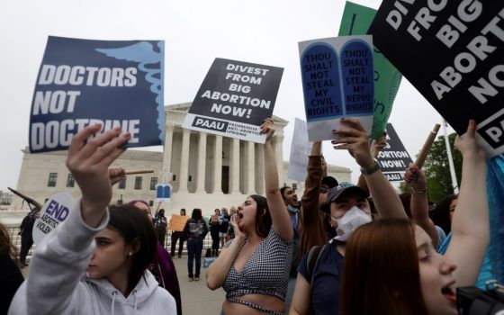 Abortion demonstrators are seen outside the U.S. Supreme Court in Washington May 3. Demonstrations followed the leak of a draft majority opinion written by Justice Samuel Alito preparing for a majority of the court to overturn the landmark Roe. 