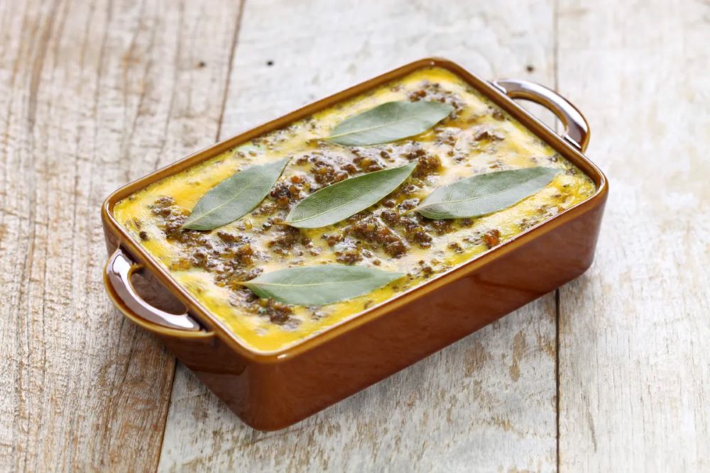 Bobotie is a homey dish of curried, spiced meat and fruit topped with an egg custard. (Getty Images via Grist)